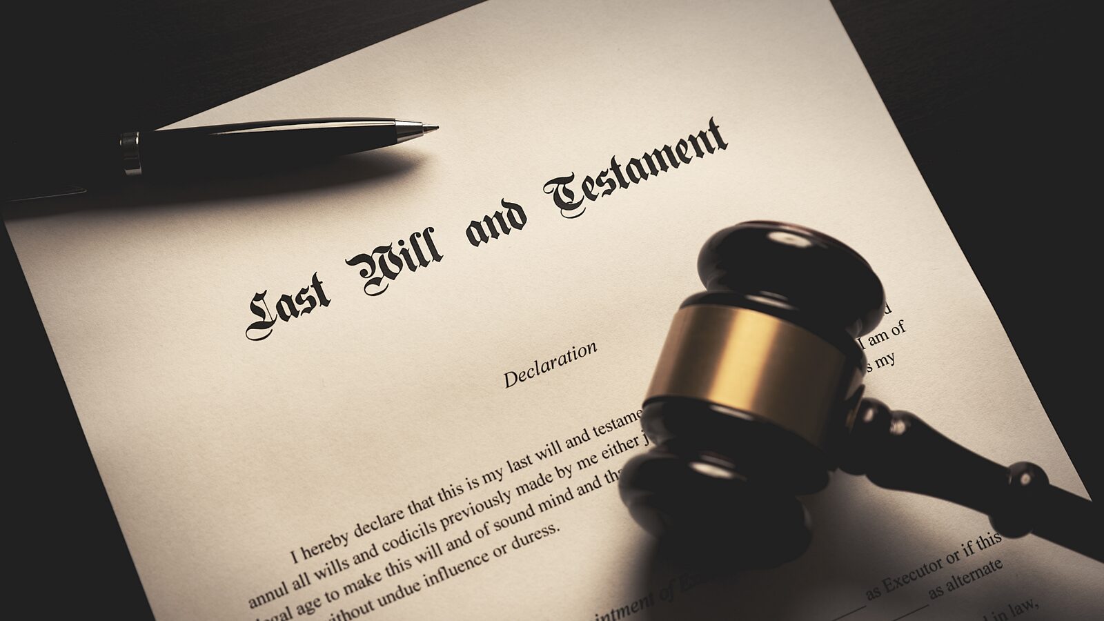 A last will and testament document with a pen and gavel