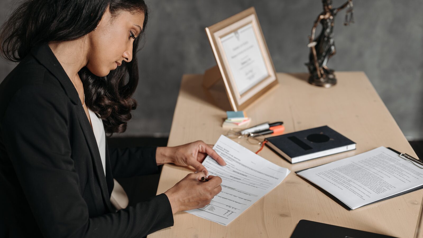An investigator working through case papers at a desk