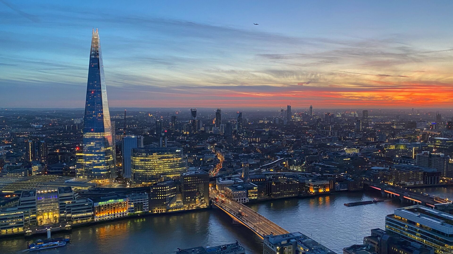 The London skyline at dusk, looking along the Thames past the Shard